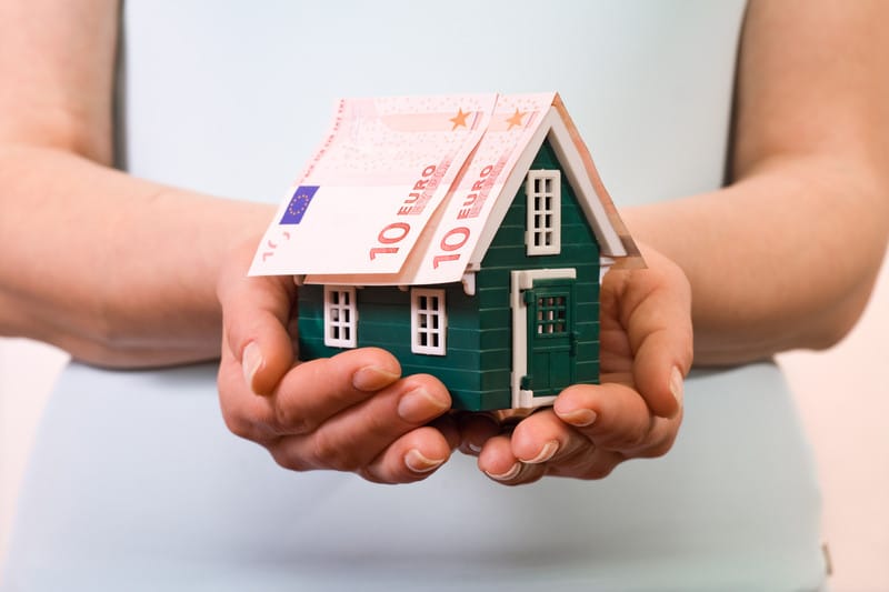 lady holding a toy house 