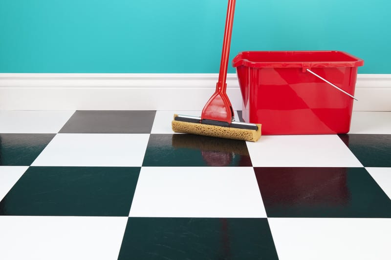 mop and bucket on tiled floor 